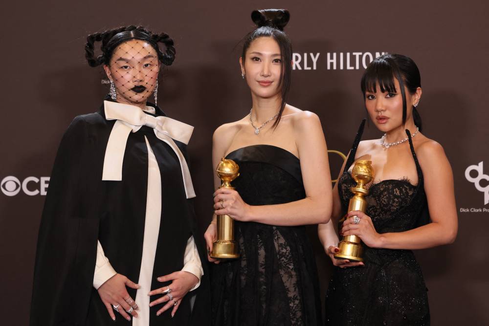 (L/R) US singer Audrey Nuna, South Korean-US singer EJAE and South Korean singer Rei Ami, winners of the Best Original Song - Motion Picture for "Golden" from "KPop Demon Hunters," pose in the press room during the 83rd annual Golden Globe Awards at the Beverly Hilton hotel in Beverly Hills, California, on January 11, 2026. (Photo by Etienne Laurent / AFP)