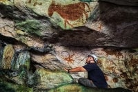 Researchers have discovered slender stenciled hands with deliberately elongated, claw-like fingernails in the caves of Sulawesi, in the oldest example of rock art in the world, dating back 67,800 years. - Courtesy of Griffith University's Maixme Aubert/AFP