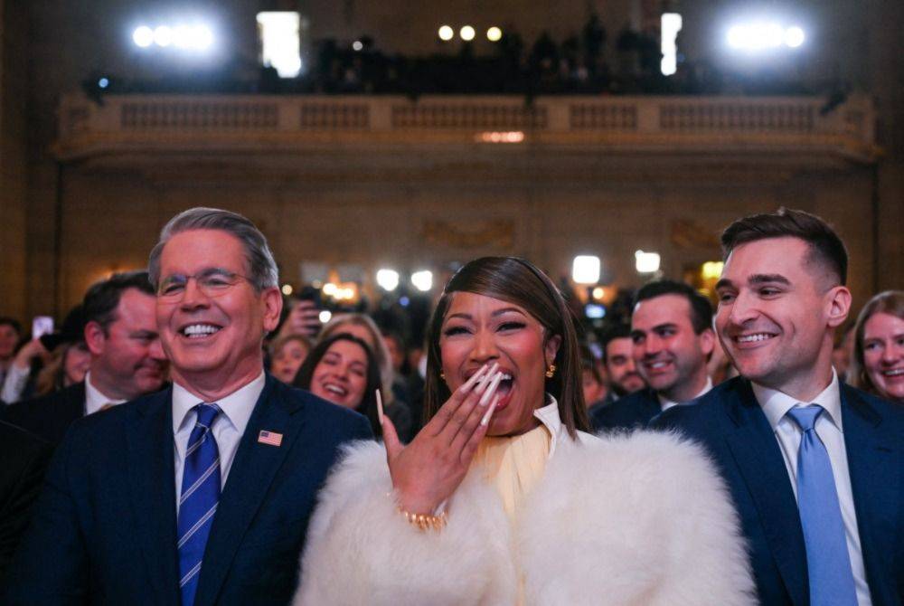 US Secretary of Treasury Scott Bessent and Trinidadian rapper and singer-songwriter Nicki Minaj listen as US President Donald Trump delivers remarks on 'Trump Accounts' at the Andrew W. Mellon Auditorium in Washington, DC. Photo by Brendan Smialowski/AFP