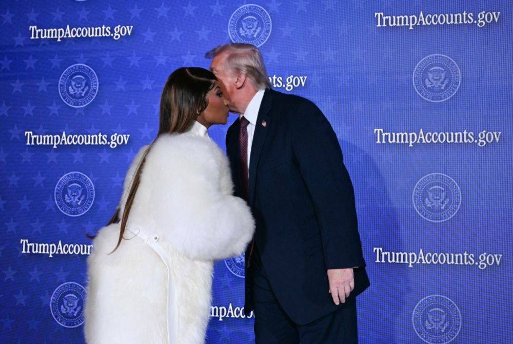 US President Donald Trump (R) greets Trinidadian rapper and singer-songwriter Nicki Minaj during an event on 'Trump Accounts' at the Andrew W. Mellon Auditorium in Washington, DC. Photo by Brendan Smialowski/AFP