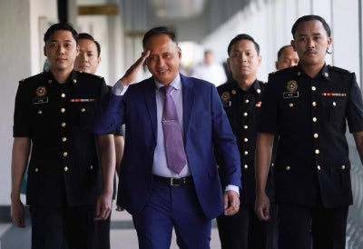 The 56-year-old was seen walking into the court complex flanked by Malaysian Anti-Corruption Commission (MACC) officers, drawing the attention of photographers and reporters who had gathered as early as 7am. - Sinar photo