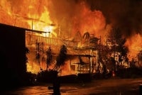 A woman and her grandson were found dead in a fire that destroyed a two-storey workers’ quarters of a shipping company on Jalan Nyigu, early today. Photo: Facebook/Sibu Sarawak page