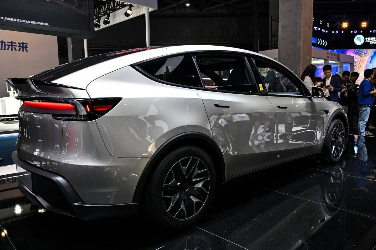 A Tesla car model Y is seen at the Tesla stand during the 8th International Import Expo (CIIE) in Shanghai on Nov 6, 2025. - (Photo by HECTOR RETAMAL / AFP)