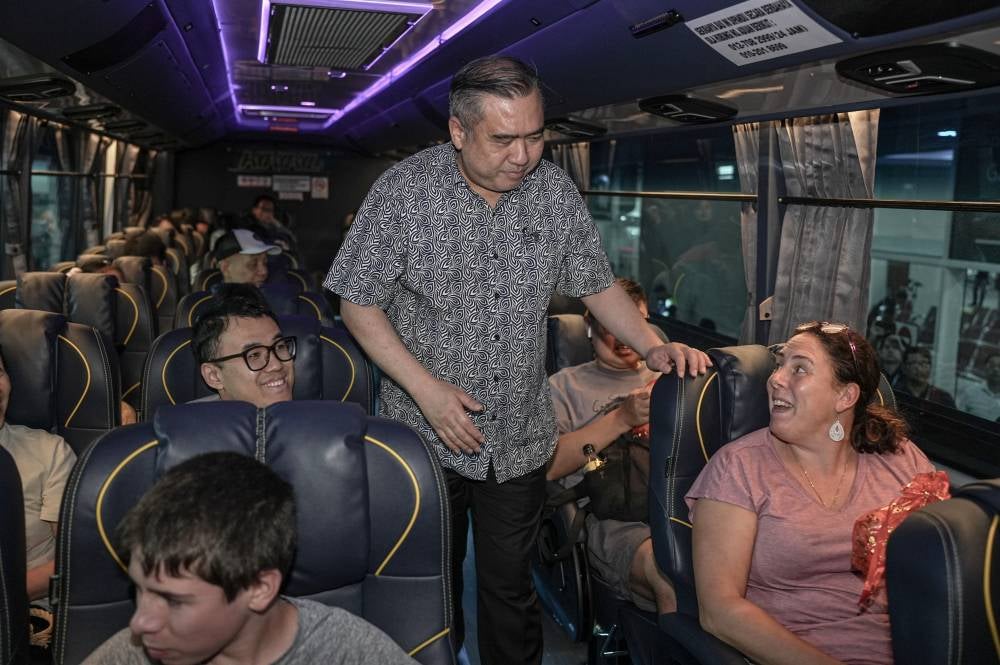 Transport Minister Anthony Loke greets bus passengers during a visit to the Southern Integrated Terminal (TBS) in conjunction with the Chinese New Year celebrations today. - Bernama photo