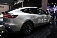 A Tesla car model Y is seen at the Tesla stand during the 8th International Import Expo (CIIE) in Shanghai on Nov 6, 2025. - (Photo by HECTOR RETAMAL / AFP)