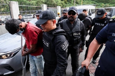 R. Arasan, 32, and R. Utes, 36, nodded in acknowledgment after the charges were read out before Magistrate Nabilah Nizam. - Bernama photo