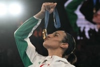 Gold medallist Algeria's Imane Khelif poses on the podium during the medal ceremony for the women's 66kg final boxing category during the Paris 2024 Olympic Games at the Roland-Garros Stadium, in Paris on Aug 9, 2024. - (Photo by MOHD RASFAN / AFP)
