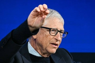 Microsoft co-founder and US philanthropist Bill Gates gestures as he speaks during the World Economic Forum (WEF) annual meeting in Davos on January 21, 2026. The World Economic Forum takes place in Davos from January 19 to January 23, 2026. (Photo by Fabrice COFFRINI / AFP)