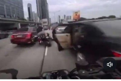 A child inadvertently caused a road accident after opening a car door in open traffic, leading to two motorcycles crashing into each other.