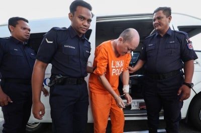 The unemployed man was charged under Section 302 of the Penal Code, which carries the death penalty or a maximum of 40 years in prison and up to 12 strokes of the cane if not sentenced to death, upon conviction. Photo by Bernama