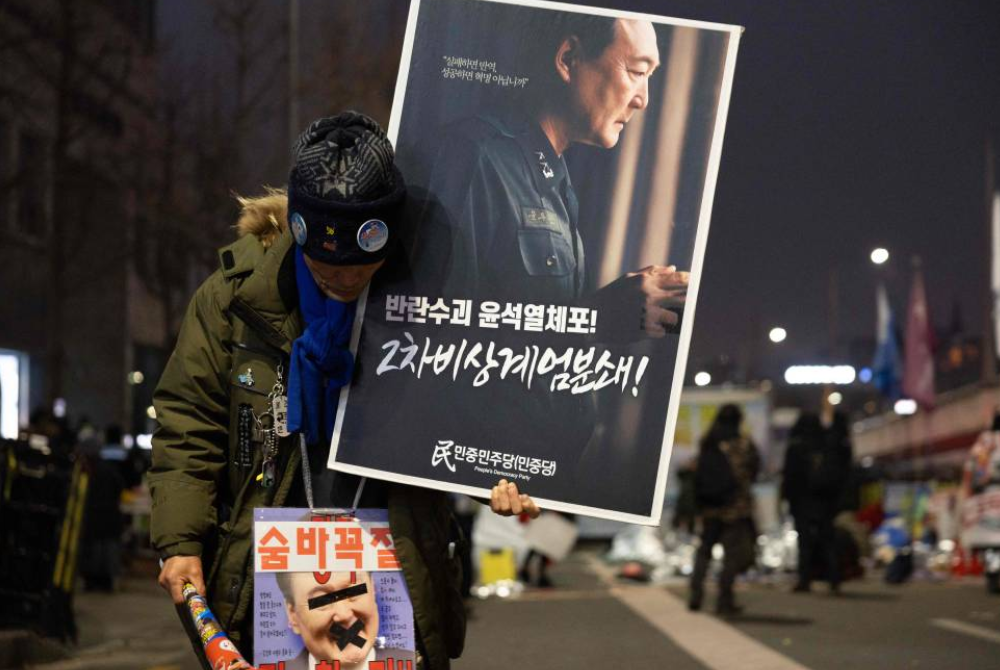 The court permitted live broadcast of Yoon being sentenced to five years in prison on Jan 16 on charges that included the obstruction of investigators' attempt to detain him last year. (Photo by YASUYOSHI CHIBA / AFP)