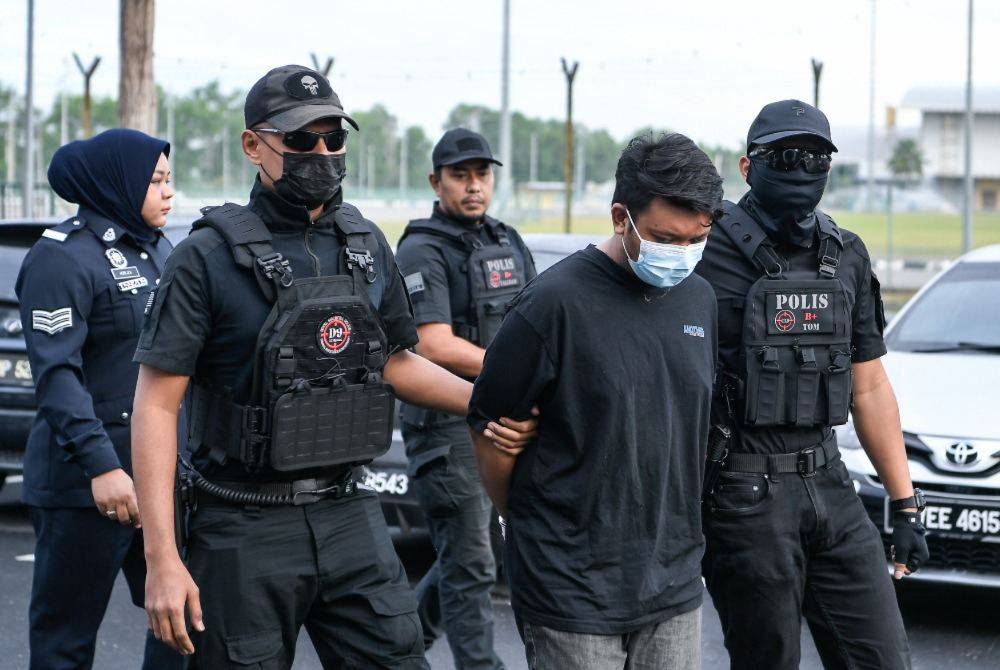 Factory worker Amirul Shafiq Shamshul Zahari was charged in the Magistrate’s Court here today with the murder of his biological mother, a bank executive, earlier this month. Photo by Bernama