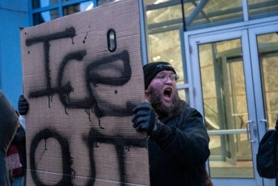 A man shouts slogans against the US Immigration and Customs Enforcement (ICE) while protesting outside the state office of US Senator Amy Klobuchar, Democrat of Minnesota, following last week fatal shooting of 37-year-old ICU nurse Alex Pretti by federal immigration agents, in Minneapolis, Minnesota, on Jan 26, 2026. - (Photo by ROBERTO SCHMIDT / AFP)