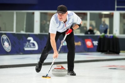 Rich Ruohonen of the United States sweeps during the Mixed Doubles Olympic Trials final at Curl Mesabi Curling Club on October 31, 2021 in Eveleth, Minnesota. Christopher Plys and Vicky Persinger of the United States defeated Rich Ruohonen and Jaime Sinclair 7-6. David Berding/Getty Images/AFP (Photo by David Berding / GETTY IMAGES NORTH AMERICA / Getty Images via AFP)