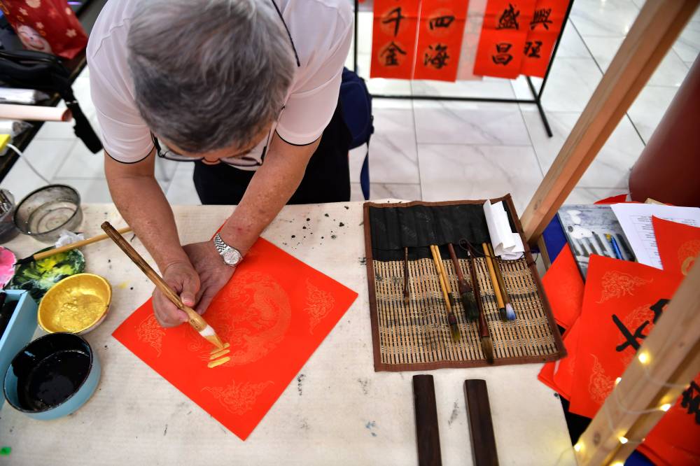 Demand for calligraphy services usually increases about one to two months before Chinese New Year, with invitations coming from schools, shopping centers, associations, and night markets selling festive goods. - Bernama photo