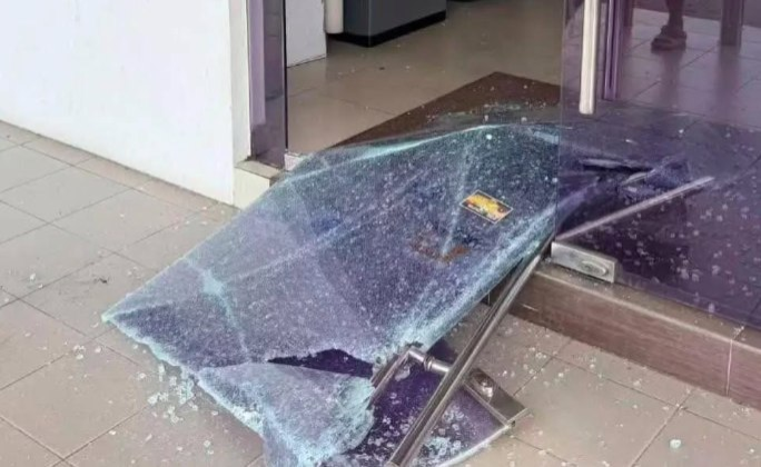 Police are investigating an incident in which the glass door of a bank in Jalan Lanang was believed to have been struck by gunfire and are working to establish the motive and identify the suspects. Photo: Social media