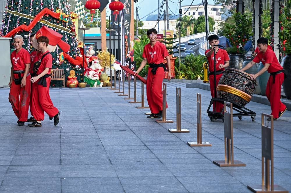 A lion dance team typically has eight to 10 members, including drummers, expanding to 20 for larger performances. - Bernama photo