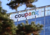 A general view shows the logo of South Korean online delivery service Coupang, at a building housing the headquarters of Coupang in Seoul on December 9, 2025. South Korean police raided the Seoul headquarters of e-commerce giant Coupang on December 9, over a recent data leak believed to have affected almost two-thirds of the country's population. (Photo by Jung Yeon-je / AFP)