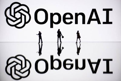 This illustration photograph taken on Oct 30, 2023, in Mulhouse, eastern France, shows figurines next to a screen displaying a logo of OpenAI, a US artificial intelligence organisation. - (Photo by SEBASTIEN BOZON / AFP)