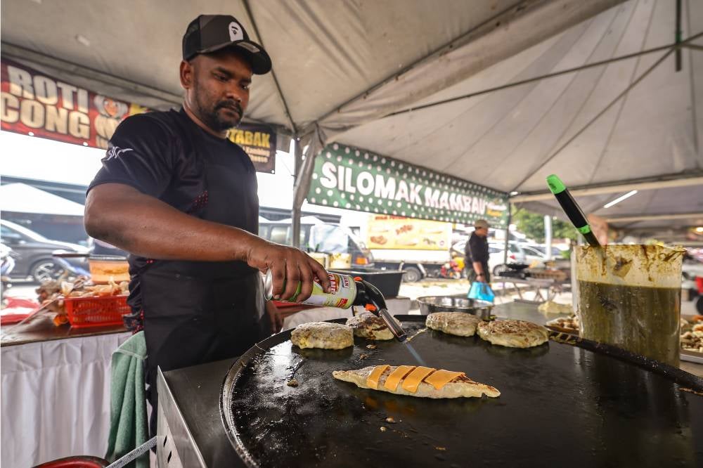 Mohamad Firdaus said his menu is priced between RM10 and RM18 and includes modern twists on traditional martabak, such as mac and cheese, spicy crispy chicken, grilled lamb with cheese, and grilled mozzarella smoked beef. - Bernama photo