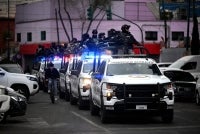 Mexican National Guard special forces patrol around the Specialized Prosecutor's Office for Organized Crime (FEMDO) headquarters in Mexico City on Feb 22, 2026. - (Photo by ALFREDO ESTRELLA / AFP)