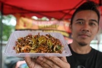 Abdul Rahman, who has only been selling charcoal-fired char kuey teow around Nusari Aman for five months, said that previously, customers had to go to Kuala Pilah if they wanted to enjoy the dish because the unique cooking method is still rarely found in this area. - Bernama photo