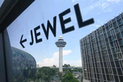 A sign shows the direction to the Jewel complex at Singapore Changi Airport in Singapore on April 10, 2025. (Photo by Roslan RAHMAN / AFP)