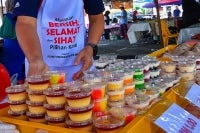 Nazrulaman said he prepares between 70 and 100 packets of nasi lemak, alongside 200 to 300 containers of cakes and puddings in various flavours each day. - Bernama photo