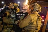 (FILES) Federal agents with Homeland Security Investigations detain a protestor wearing an "Antifa" shirt outside a residential building in Minneapolis, Minnesota, on Feb 5, 2026. - (Photo by CHARLY TRIBALLEAU / AFP)