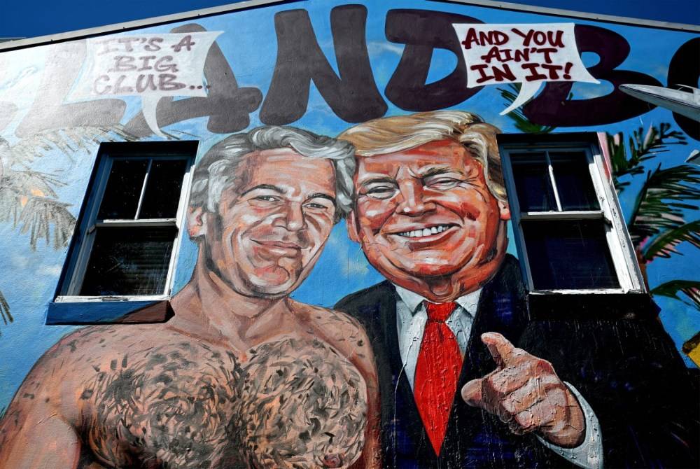 A mural titled "Island Boys" by artist Scott Marsh is seen on a building wall in Sydney on Feb 24, 2026, depicting Jeffrey Epstein alongside several high-profile figures referenced in the recently released Epstein documents. - (Photo by SAEED KHAN / AFP)