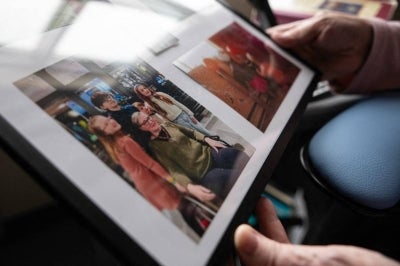 Rachel Fournier, who has requested medical assistance in dying due to a brain tumor, gazes at framed family photos at a palliative care center in Boucherville, Quebec Province, Canada. Photo by Sebastien ST-Jean/AFP