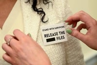 A woman wears a “Release The Files” pin at a press event with survivors of convicted sex offender Jeffrey Epstein, held by the Democratic Women's Caucus in advance of President Donald Trump's State of the Union address on Capitol Hill in Washington DC on Feb 24, 2026. - (Photo by ALEX WROBLEWSKI / AFP)