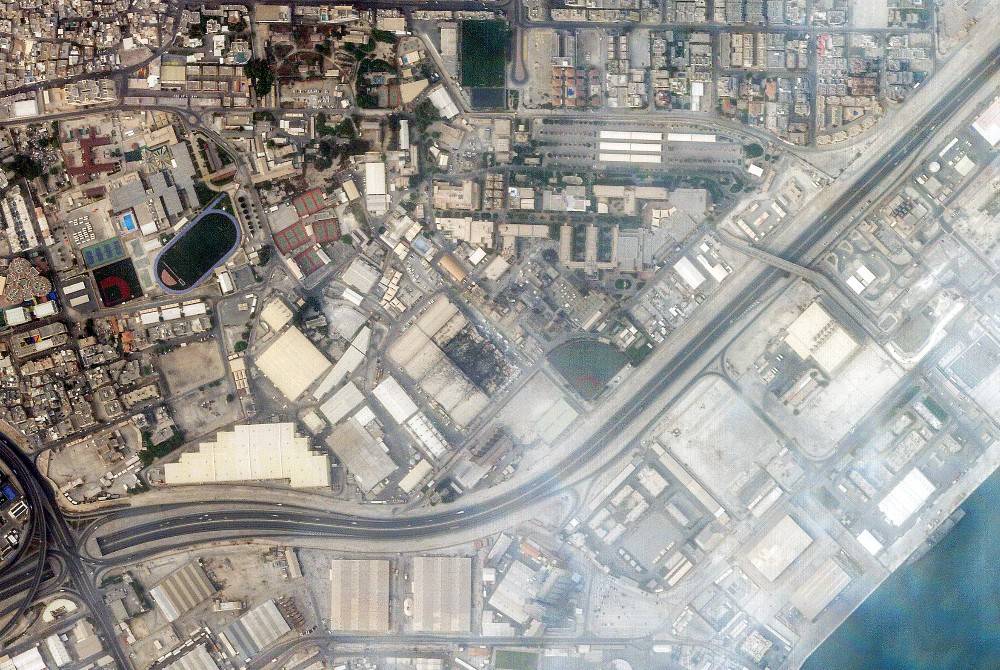 This handout satellite image taken by 2026 Planet Labs PBC on March 1, 2026 shows a view of smoke rising from damage at the US Fifth fleet naval base in Bahrain's capital Manama after it was hit by Iranian strikes. - (Photo by 2026 Planet Labs PBC / AFP)
