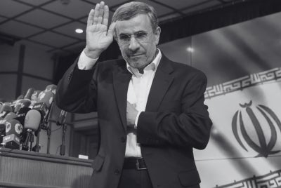 Iranian former president Mahmoud Ahmadinejad waves after registering his candidacy for Iran's upcoming presidential election in Tehran on June 2, 2024. (Photo by ATTA KENARE / AFP)