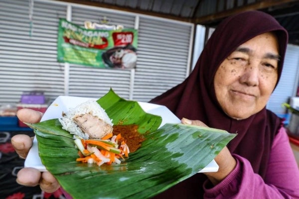 Mak Yah said the small packets are wrapped in banana leaves, along with gulai and ikan tonggol (mackerel tuna), which enhances the aroma and attracts customers, in line with the price offered. Photo by Bernama