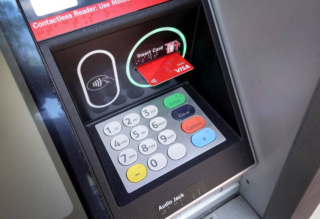 Customers of all banks in Malaysia can withdraw cash at any bank’s automated teller machine (ATM) or smart recycler machine (SRM) without paying the RM1 fee starting July 1 2026. AFP photo.