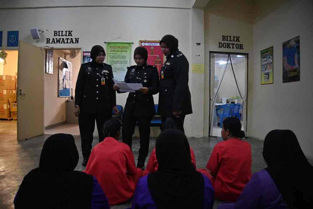 Farah, Deputy Prison Superintendent Najah Mohd Noor and Aznee review the health records of a female inmate attending a check-up at the clinic in Pokok Sena Prison.