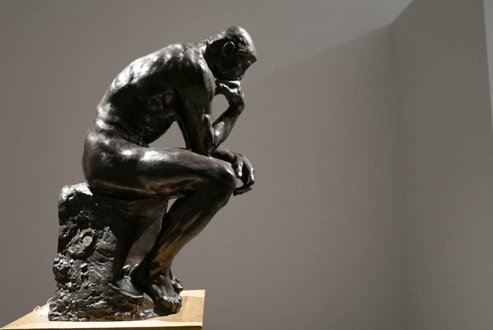 The sculpture “The Thinker” by Auguste Rodin, which is part of a collection titled "Le Grand Style: An apartment on the Quai d’Orsay" curated by Alberto Pinto, during a touring exhibition at Christie’s New York, April 8, 2022. - (Photo by TIMOTHY A. CLARY / AFP)