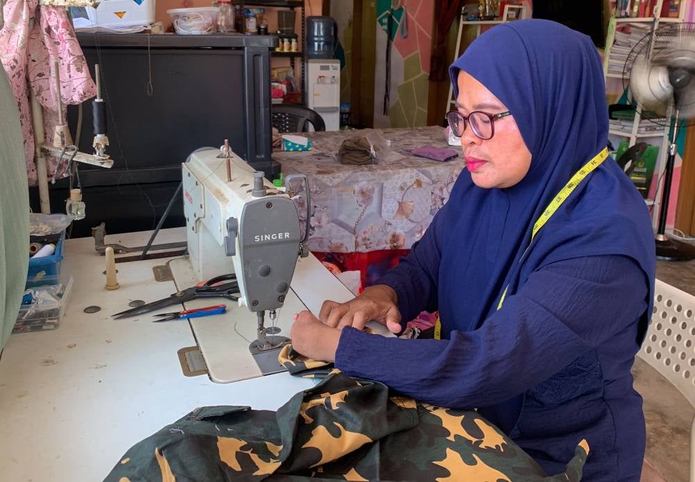 For 46-year-old Liza Mamat, her physical disability has never been a reason to depend on others. Instead, it became the motivation to master a skill that could secure her family’s future. - Photo by Bernama