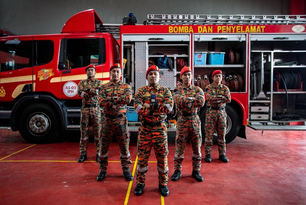 Senior Fire Officer I Hassanuddin Tabaddang, a member of JBPM’s Special Tactical Operation and Rescue Team of Malaysia (STORM) and team posing for a photo during an interview by Bernama at the Ipoh fire station, recently. - Photo by Bernama