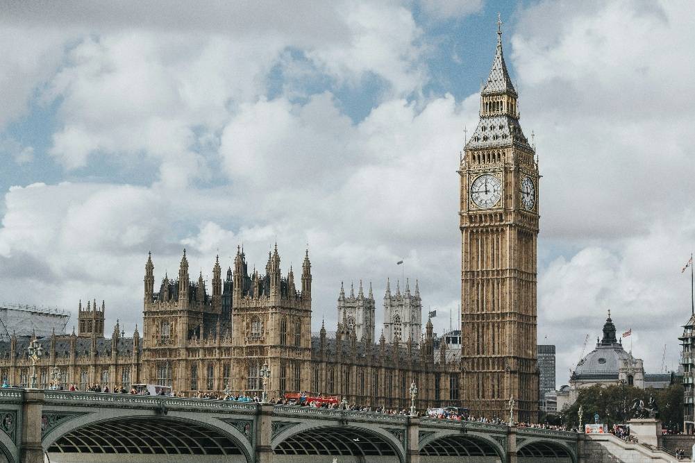 The iconic silhouette of Big Ben and the majestic Houses of Parliament dominate the River Thames waterfront, situated just across the architectural marvel of the London Eye, which offers unmatched panoramic views of the city’s sweeping skyline.