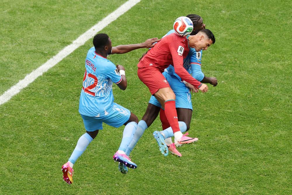 Cristiano Ronaldo #7 of Portugal competes for a header against Chancel Mbemba #22 and Axel Tuanzebe #4 of Congo DR during the FIFA World Cup 2026 Group K match between Portugal and Congo DR at Houston Stadium. Photo: Getty Images/AFP