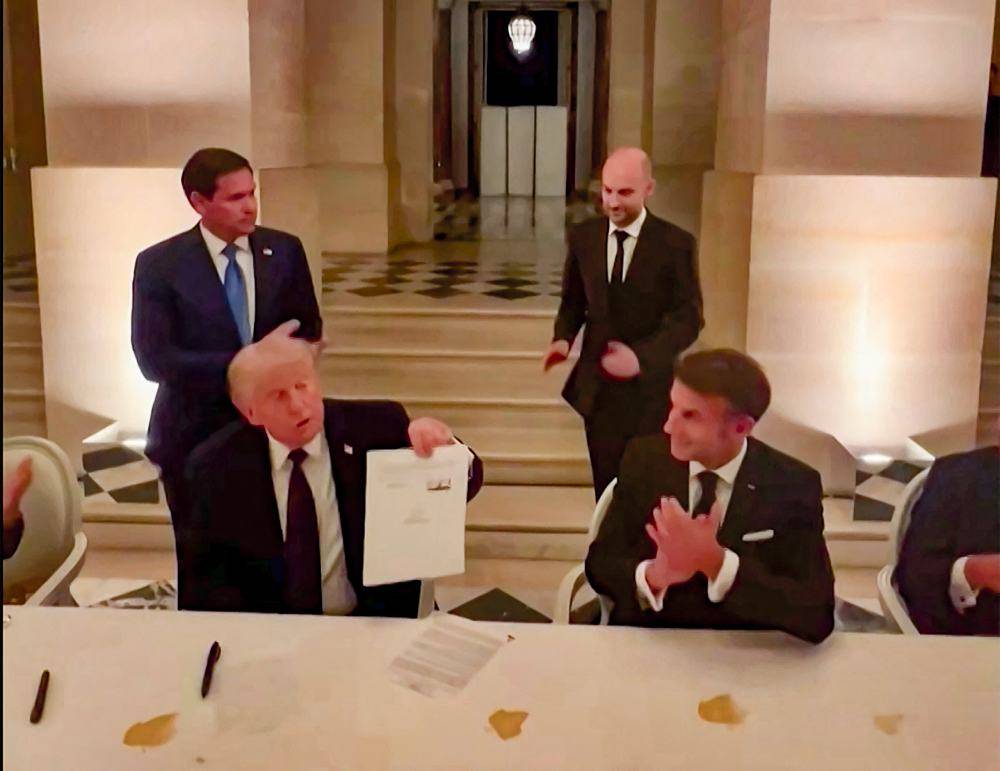 US President Donald Trump (left) and France's President Emmanuel Macron (right) during the signing of a deal with Iran to end the Middle East war, inside Chateau de Versailles, in Versailles southwest of Paris. Photo by @EmmanuelMacron/X/AFP