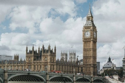 The iconic silhouette of Big Ben and the majestic Houses of Parliament dominate the River Thames waterfront, situated just across the architectural marvel of the London Eye, which offers unmatched panoramic views of the city’s sweeping skyline.