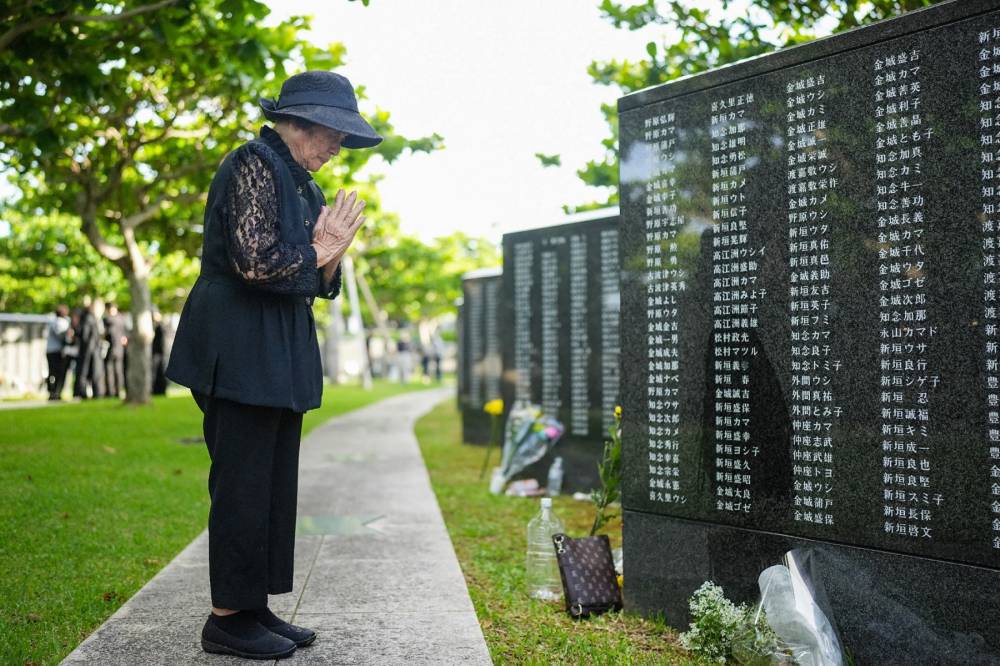 A woman prays for lost loved ones while visiting the Peace Memorial Park. AFP file photo
