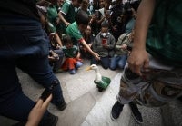 People gather around Merlin the duck in Mexico City on June 18 2026. Merlin is a two-year-old duck that captured the country's attention when it appeared on the street wearing the national team's jersey alongside its owner, a street vendor. (Photo by AFP)