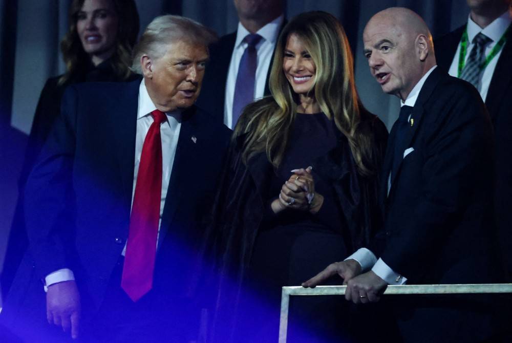 (From L) US President Donald Trump, US First Lady Melania Trump and Italian Fifa President Gianni Infantino chat after the results of the draw for the 2026 FIFA Football World Cup taking place in the US, Canada and Mexico, at the Kennedy Center, in Washington, DC, on Dec 5, 2025. - (Photo by Dan Mullan / POOL / AFP)