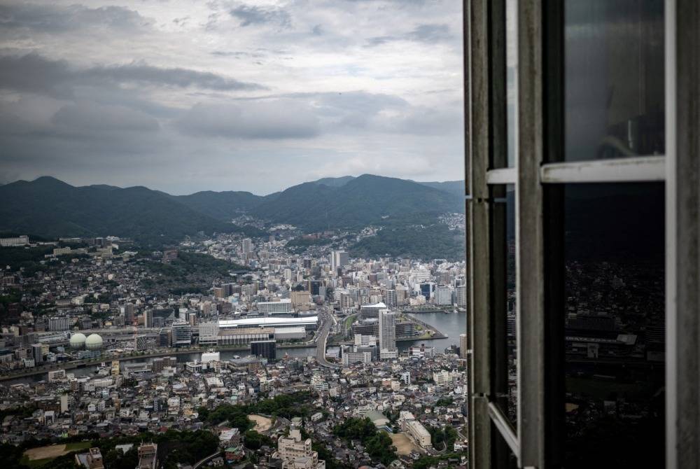 A general view of Nagasaki is seen from the observation deck of Inasayama on Aug 8, 2025 ahead of the 80th anniversary of the atomic bombing of Nagasaki. - (Photo by PHILIP FONG / AFP)