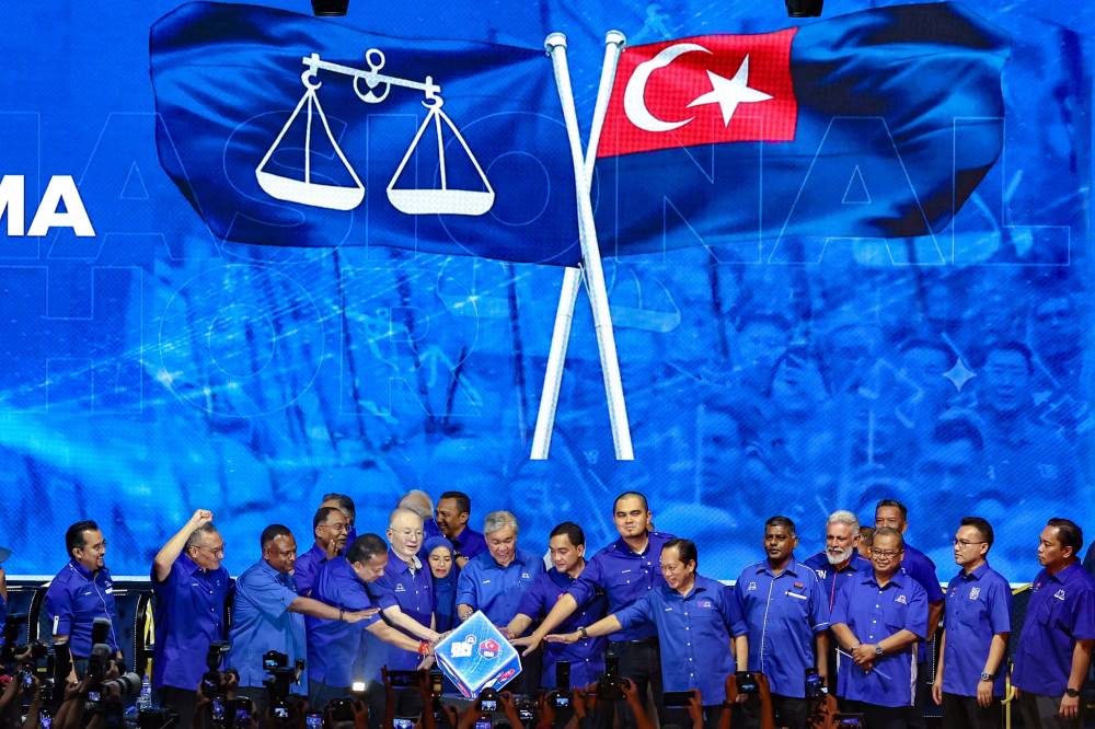 Barisan Nasional President Datuk Seri Dr Ahmad Zahid Hamidi (centre) together with BN top leadership perform the symbolic gesture at the Launch of the Barisan Nasional (BN) Johor Election Machinery, for the 16th Johor State Election (PRN), at the Educity Complex Indoor Stadium on June 7.