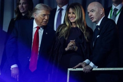 (From L) US President Donald Trump, US First Lady Melania Trump and Italian Fifa President Gianni Infantino chat after the results of the draw for the 2026 FIFA Football World Cup taking place in the US, Canada and Mexico, at the Kennedy Center, in Washington, DC, on Dec 5, 2025. - (Photo by Dan Mullan / POOL / AFP)